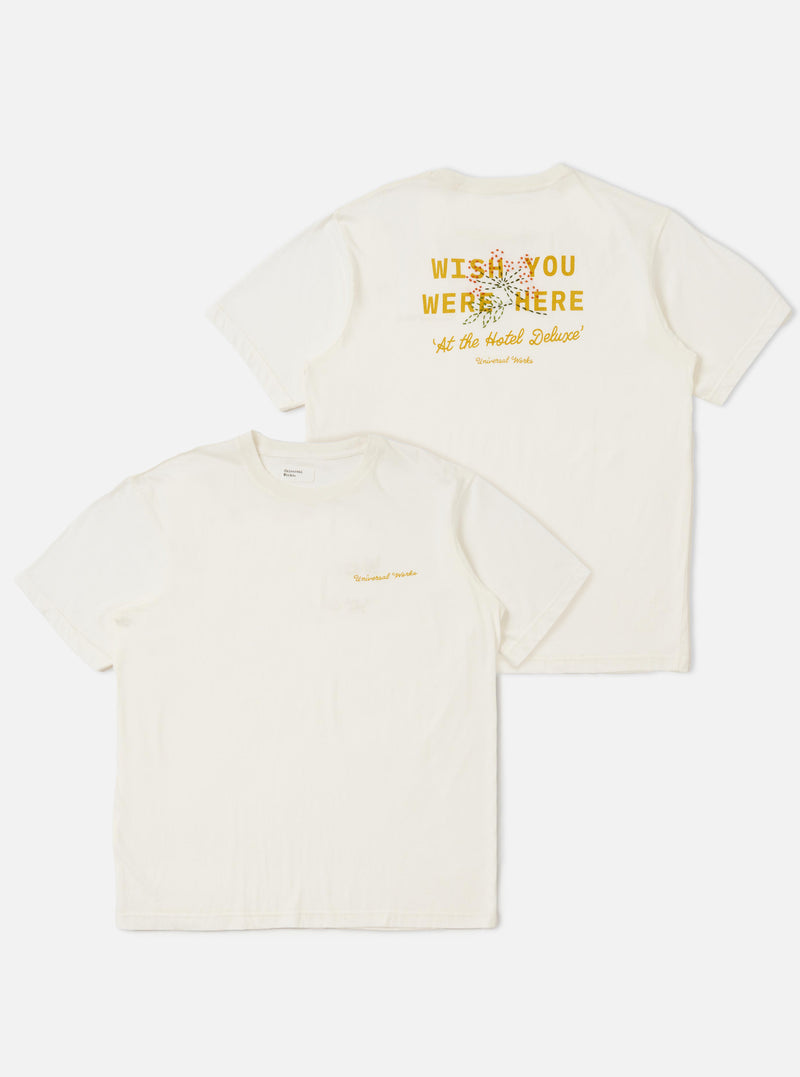 The Ecru Single Jersey Wish Wish You Were Here Tee is displayed flat against a plain white background. The shirt features two identical graphics of a tropical island scene with palm trees and the text Wish You Were Here printed on the front. It has a classic crew neck and short sleeves.