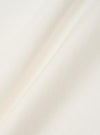 A close-up fabric swatch of the Ecru Single Jersey Wish Wish You Were Here Tee. The image highlights the textured, cream-colored cotton jersey material, showing the fine knit and soft surface of the fabric.