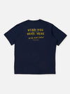 The Navy Single Jersey Wish Wish You Were Here Tee is shown from the back, laid flat against a plain white background. The image highlights the smooth navy blue cotton fabric and the clean, straight hem of the short-sleeved t-shirt.