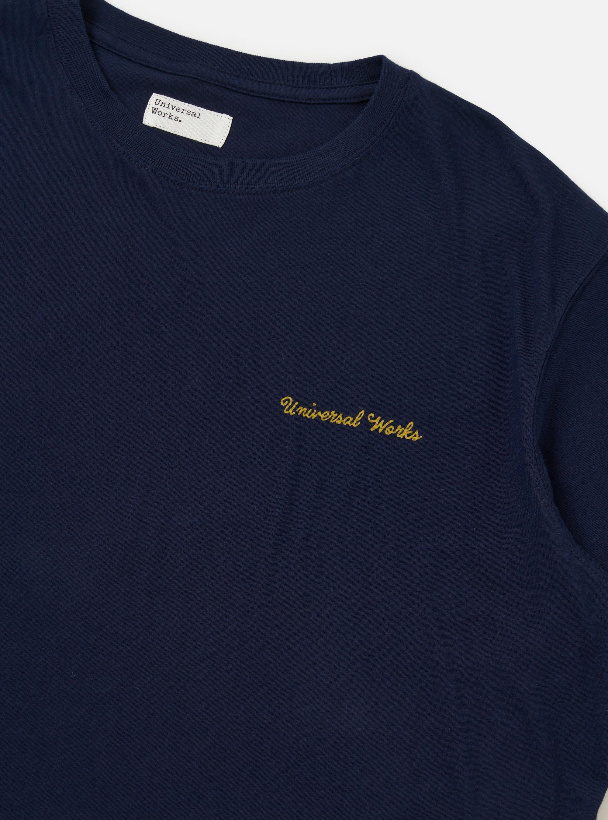 The Navy Single Jersey Wish Wish You Were Here Tee is displayed from the back, laid flat against a plain white background. The image highlights the dark navy blue cotton fabric and a small, white "Wish You Were Here" graphic printed on the upper back near the neckline.