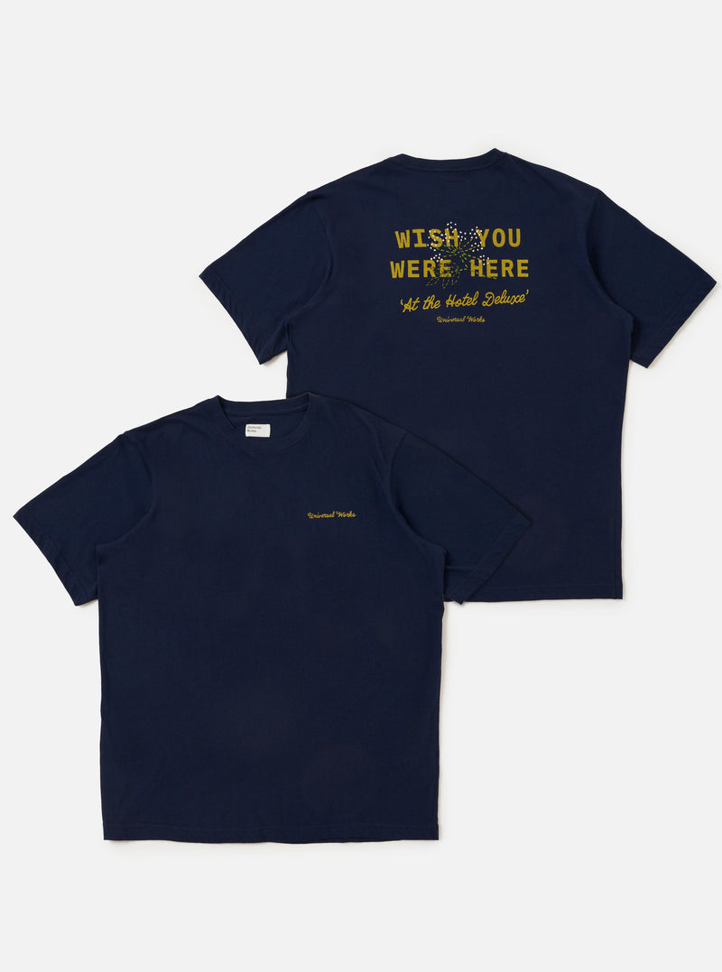 The Navy Single Jersey Wish Wish You Were Here Tee is displayed flat against a plain white background, shown from both the front and back. The navy blue t-shirt features a white graphic on the chest and a larger matching graphic on the back. It has a classic crew neck and short sleeves.