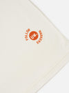 An Ecru Single Jersey Trail Trail To Hotel Delux Tee is shown from a rear perspective, laid flat against a solid white background. The image highlights the clean finish of the back, the short sleeves, and the self-bound crew neck.