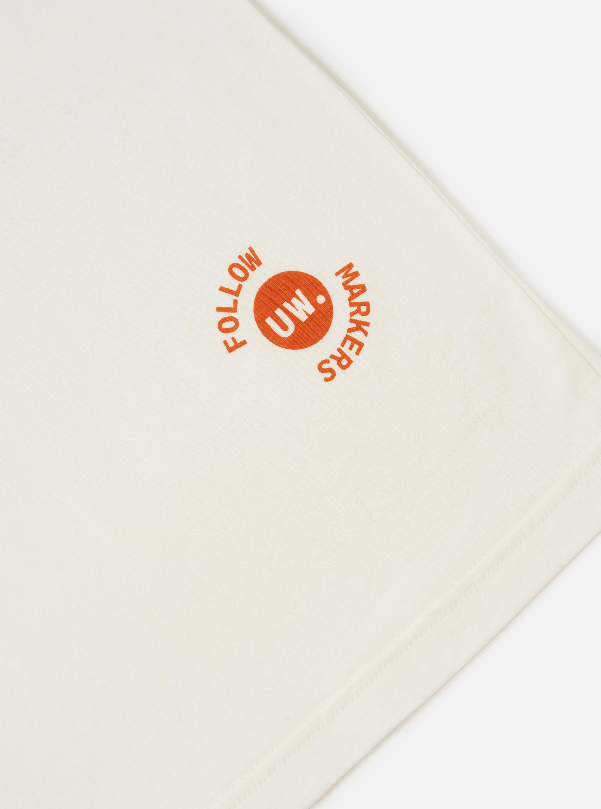 An Ecru Single Jersey Trail Trail To Hotel Delux Tee is shown from a rear perspective, laid flat against a solid white background. The image highlights the clean finish of the back, the short sleeves, and the self-bound crew neck.