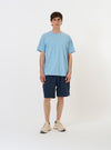 The Pale Blue Piquet Core Tee is displayed flat against a solid white background. The short-sleeve t-shirt features a simple, regular fit, a self-bound crew neckline, and a small woven brand label at the hem.