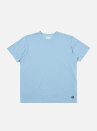 The Pale Blue Piquet Core Tee is shown laid flat against a plain white background. The short-sleeve t-shirt features a classic crew neck with a self-bound collar and a clean, regular-fit silhouette.