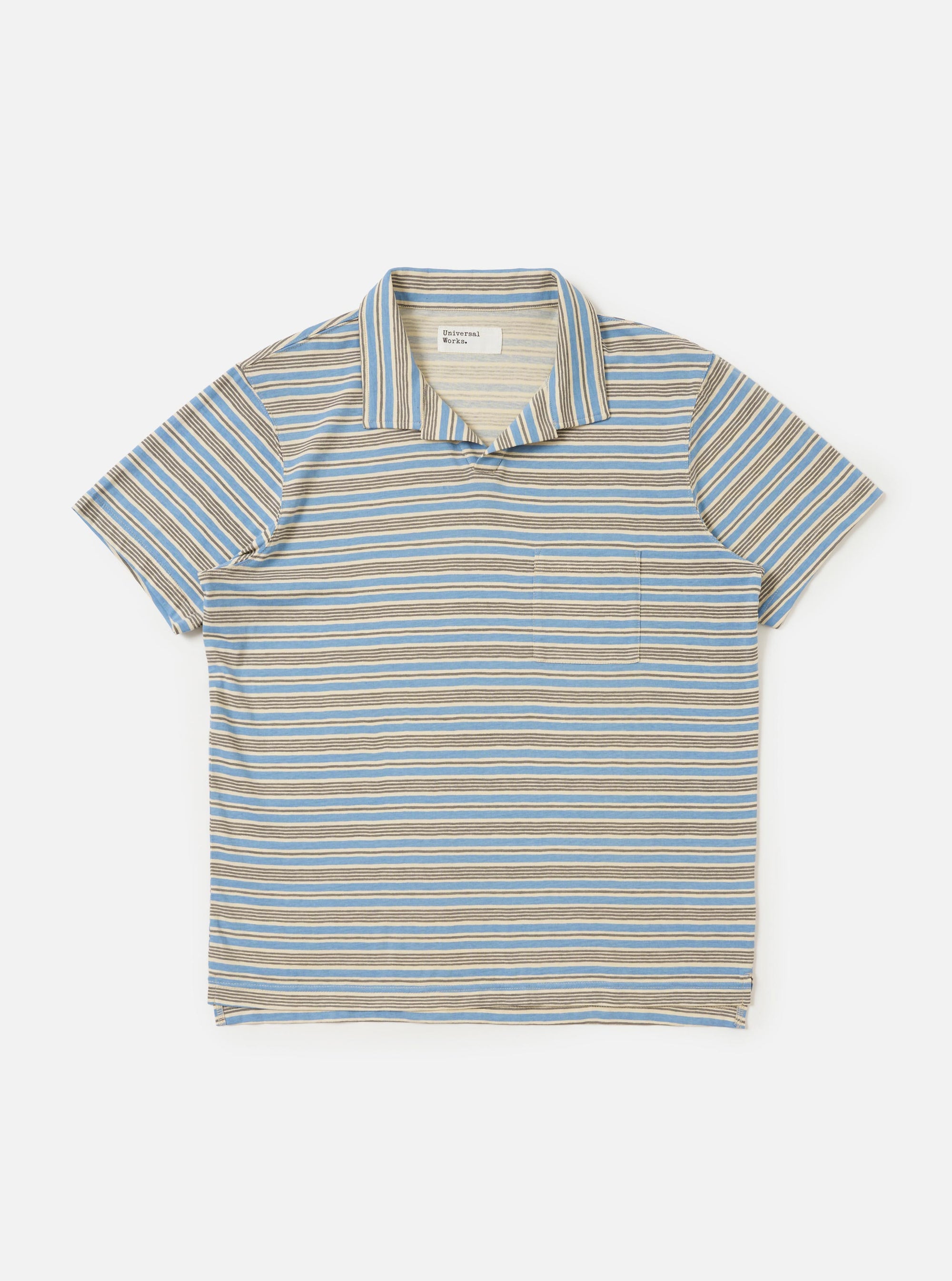 A Pale Blue OS Stripe Jersey Vacation Polo is shown laid flat against a plain white background. The garment features horizontal light blue and white stripes, a standard polo collar, and a short-sleeved silhouette.