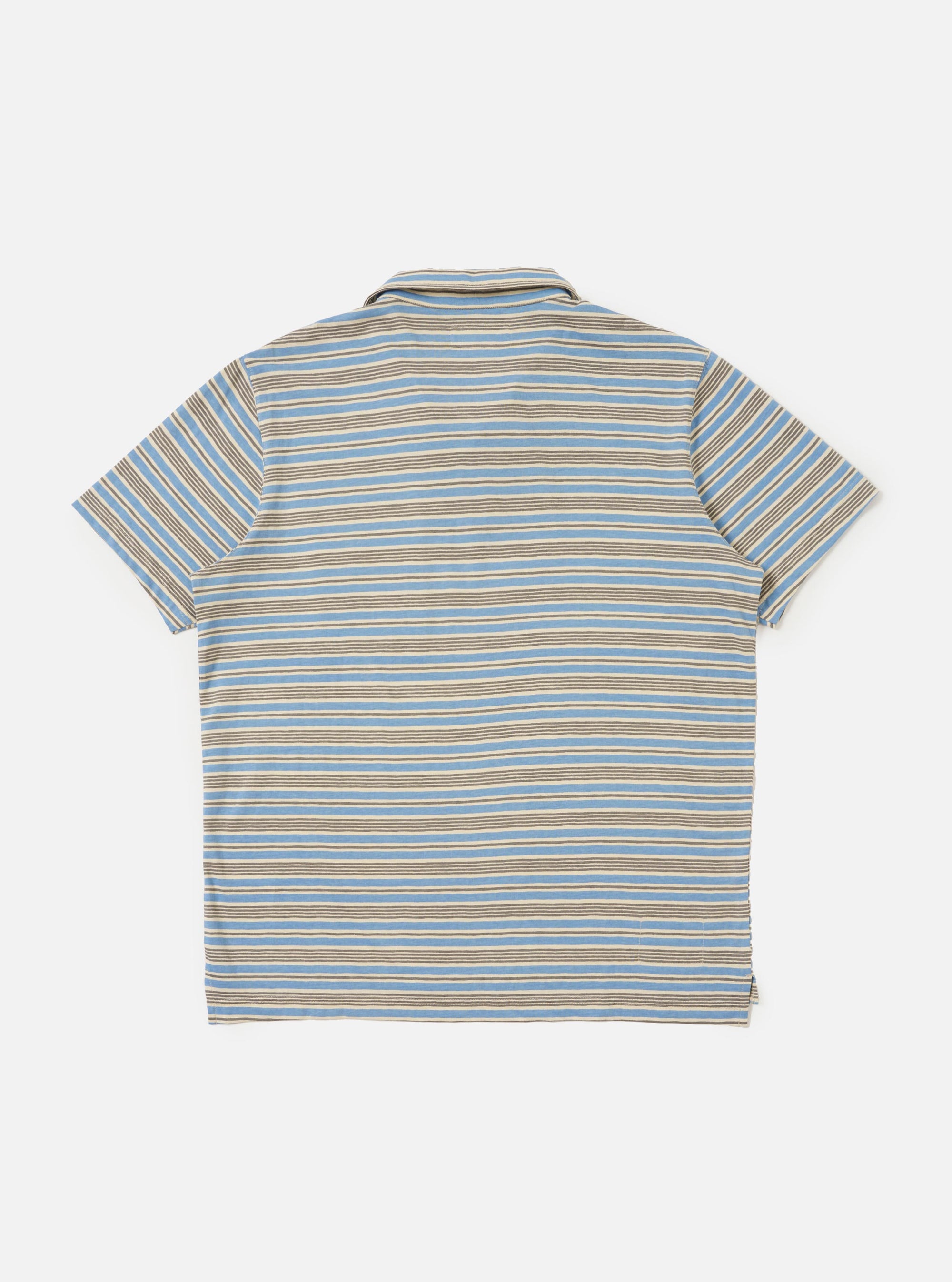 The Pale Blue OS Stripe Jersey Vacation Polo is shown from the back, laid flat against a plain white background. The image highlights the horizontal light blue and white stripes, the straight hem with a slight drop, and the small side vents.