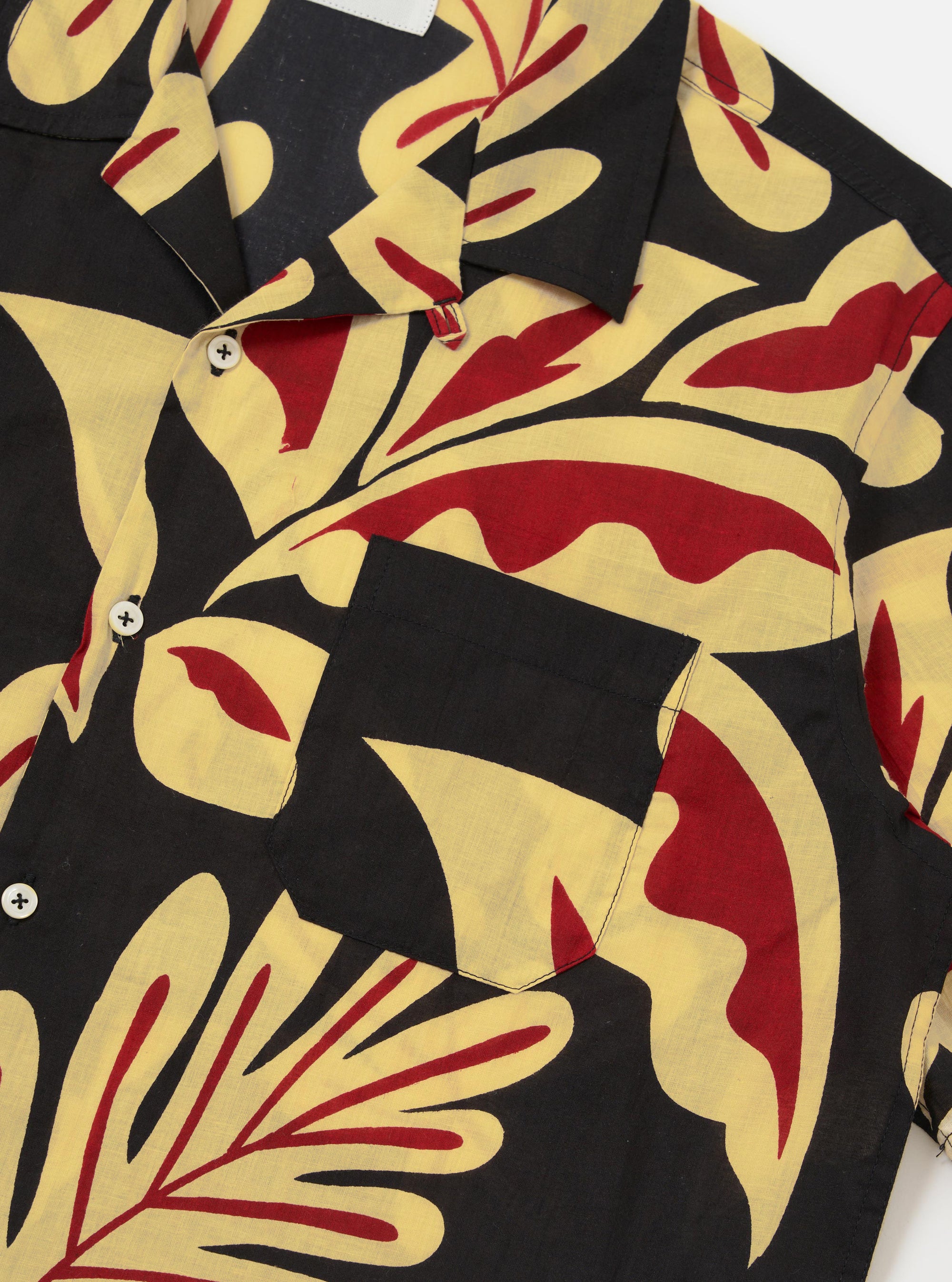 The Black Baja Print Road Shirt is shown from a rear perspective, displayed flat against a plain white background. The image highlights the short sleeves, straight hem, and the all-over patterned Baja print in black and grey.
