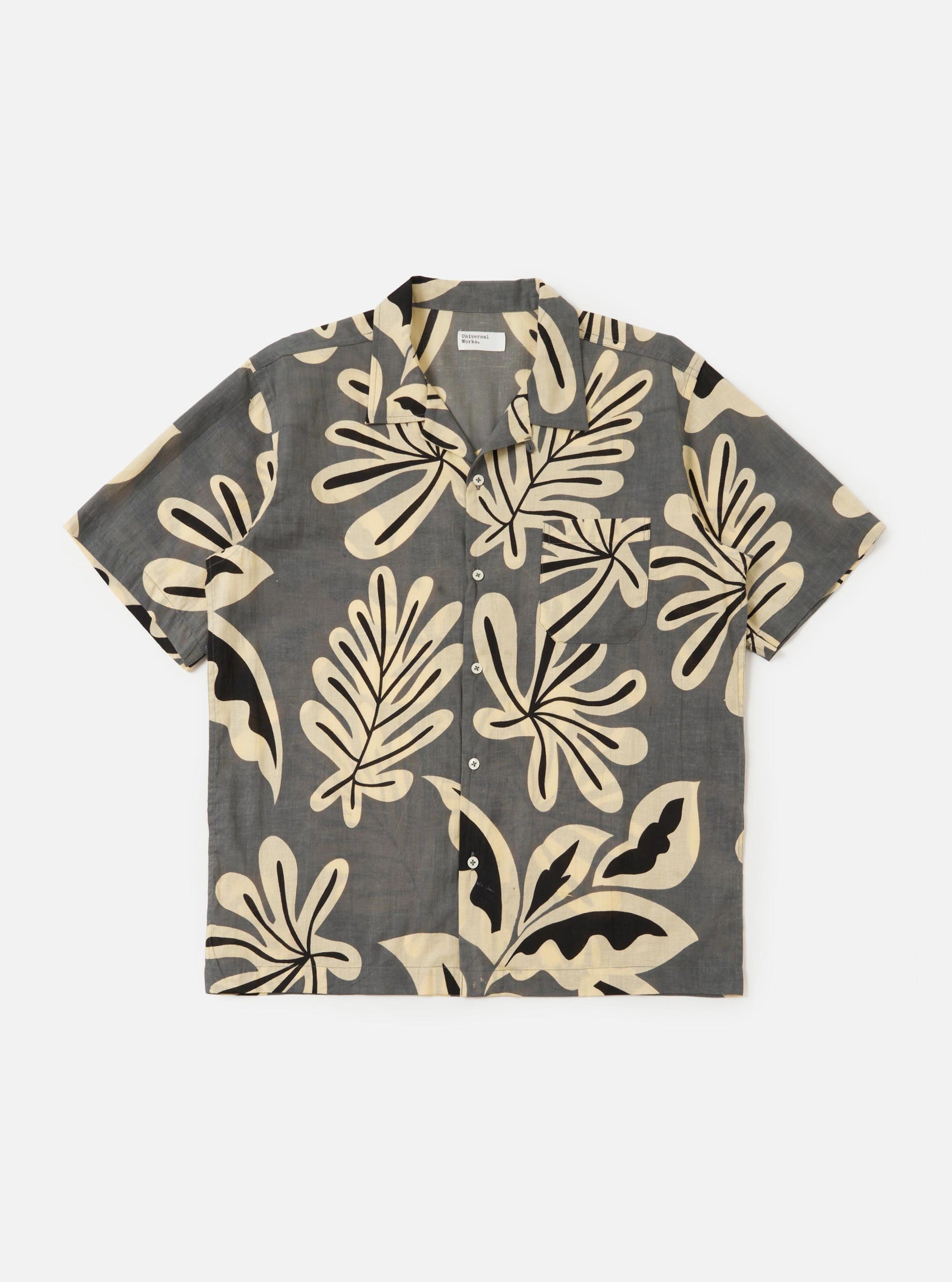 The Grey Baja Print Road Shirt is shown laid flat against a solid white background. The short-sleeve shirt features a grey and white botanical print throughout, a relaxed camp collar, a button-down front, and a single chest patch pocket.
