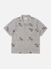 The Grey Hand Embroidered Stripe Cotton Road Shirt is shown laid flat against a solid white background. The shirt features a camp collar, a full button-down front, and short sleeves. The grey cotton fabric is detailed with vertical hand-embroidered stripes in a contrasting dark tone.