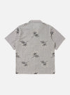 The Grey Hand Embroidered Stripe Cotton Road Shirt is shown from the back, displayed flat against a plain white background. The image highlights the short sleeves, a straight hem, and the subtle vertical stripe pattern of the grey cotton fabric.