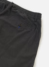 A close-up view of the back of the Charcoal Seattle Cotton Pleated Track Pant focuses on the waistband and two rear pockets. One pocket is a buttoned jetted style, while the other features a buttoned flap. The charcoal grey cotton fabric is shown against a plain white background.