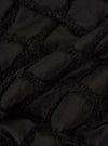 A close-up fabric swatch of the Black 3D Check Road Shirt showcases a textured, three-dimensional woven pattern in black and dark grey. The image focuses on the intricate grid-like structure of the cotton fabric.