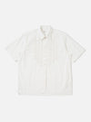 A White Poplin Frill Shirt is shown laid flat against a solid white background. The garment features a classic pointed collar, a full button-down front, and a vertical ruffled frill detail running alongside the central placket. The long sleeves are laid out to the sides, and the hem is straight.