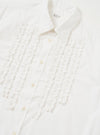 The White Poplin Frill Shirt is shown from a rear perspective, laid flat against a solid white background. The image highlights the back yoke and the straight-cut hem of the garment.