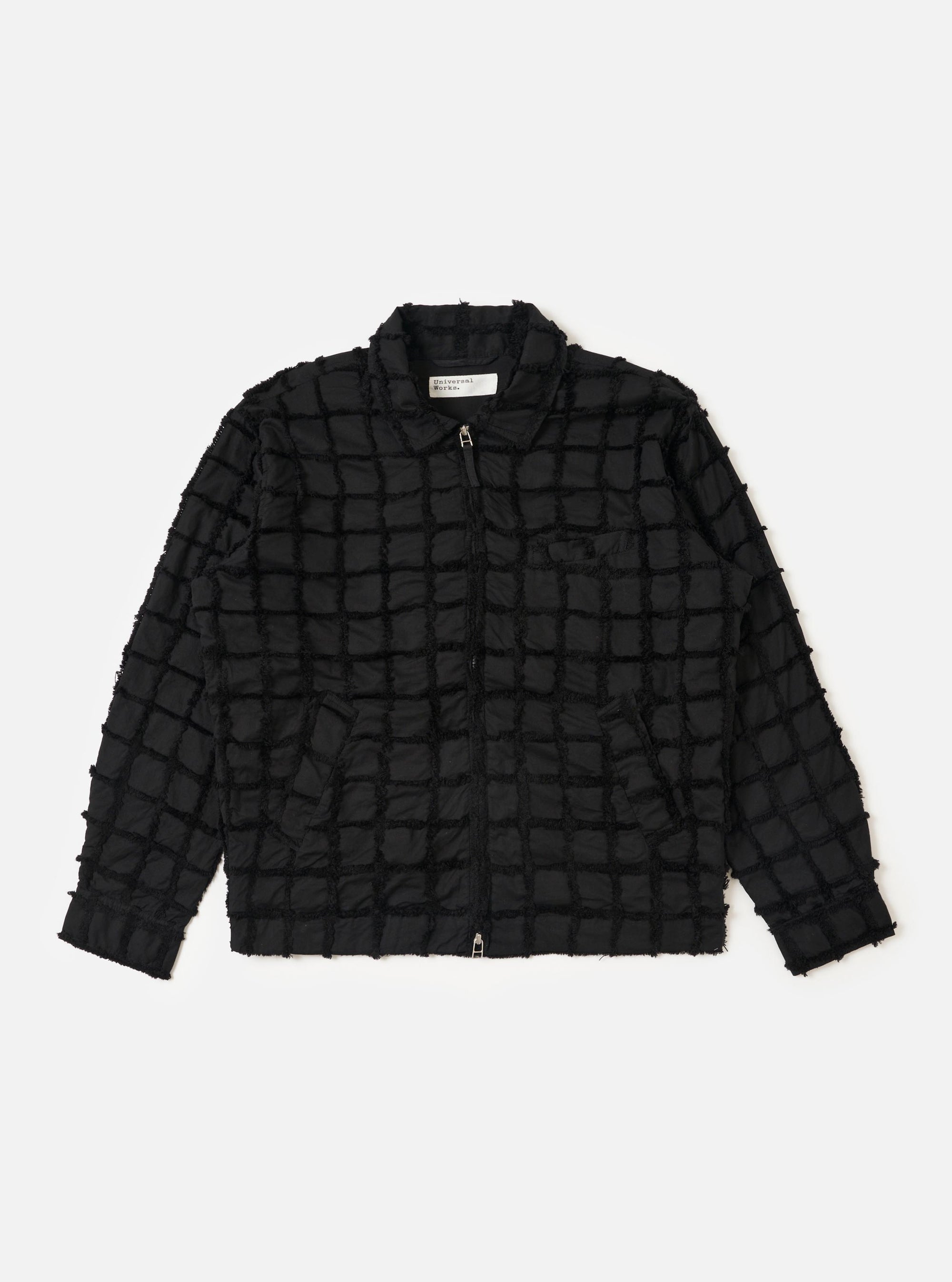 The Black 3D Check Windcheater Jacket is shown laid flat against a plain white background. The jacket features a prominent black and grey 3D checkered pattern, a classic pointed collar, a full-length front zipper, and two large slanted welt pockets at the waist. The hem and cuffs are elasticated, and the garment is displayed without a model or mannequin.