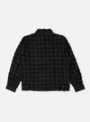 The back of the Black 3D Check Windcheater Jacket is shown from a rear perspective, laid flat against a plain white background. The image highlights the jacket's short, coach-style silhouette, a classic pointed collar, and the textured 3D check pattern of the black fabric.