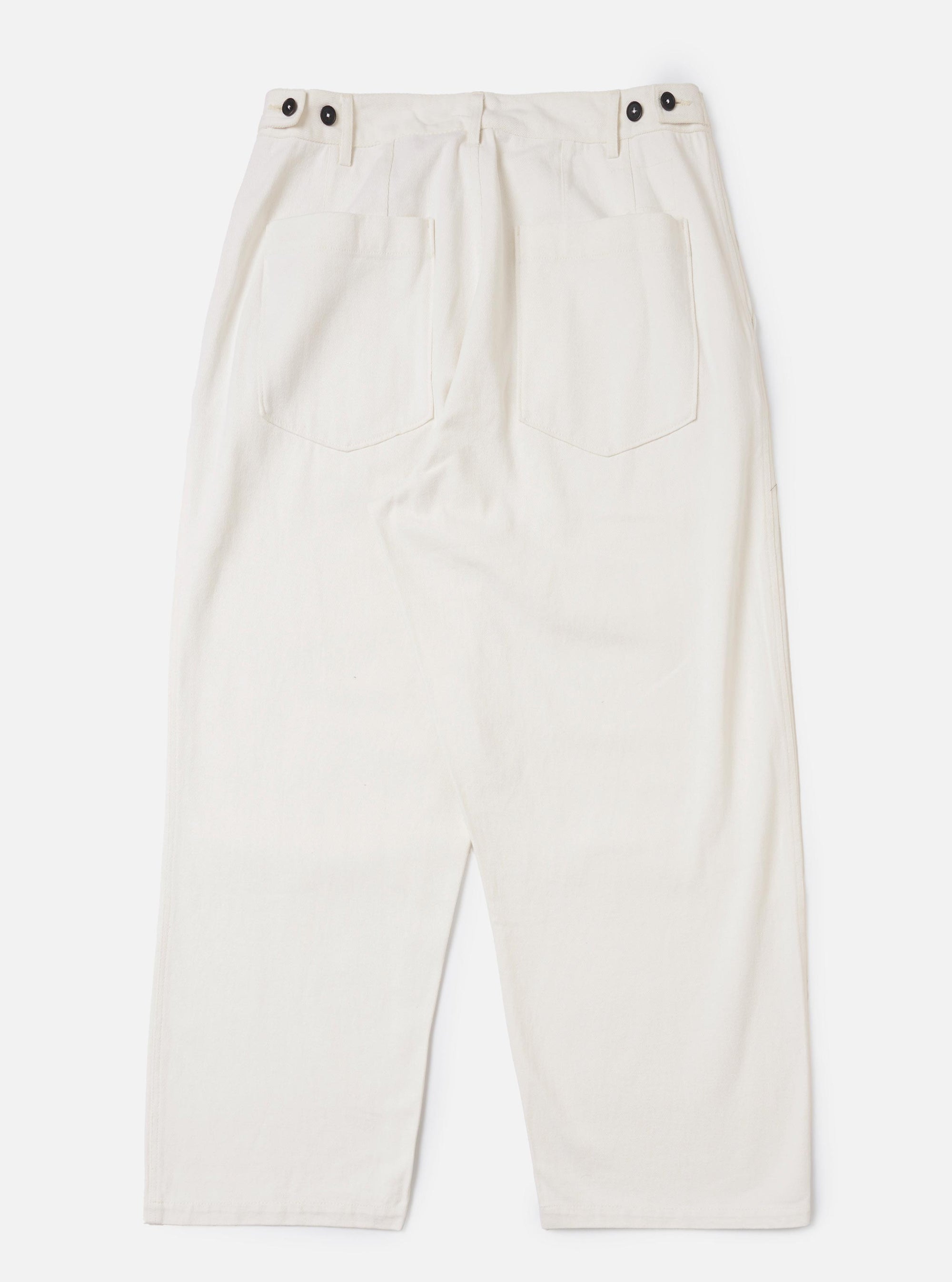 The Ecru Slub Drill Dutch Pant is shown from the back, laid flat against a plain white background. The image highlights the two large rear patch pockets and the loose, wide-leg cut of the trousers.
