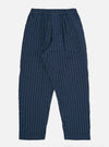 The Navy Chester Stripe Oxford Pant is displayed flat against a plain white background. The trousers feature a loose, wide-leg fit with vertical navy and white pinstripes, a drawstring waistband, and a single pleat in the front.