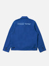Back view of the Paraboot x Universal Works Navy Derek Twill Warmus Jacket on a white background. The jacket is navy with light blue text that reads "Manufacture de Chaussures EXTRA".