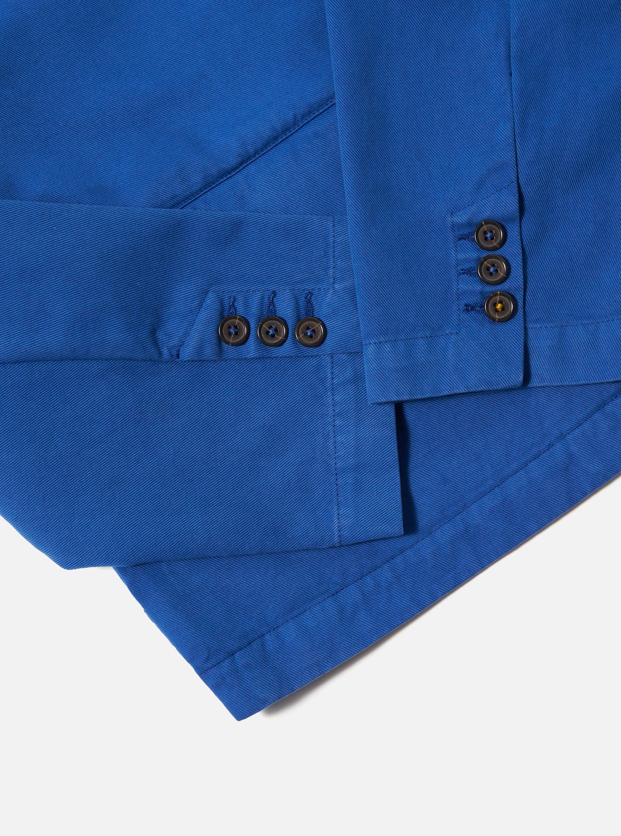 Close-up of the Paraboot x Universal Works Navy Derek Twill Warmus Jacket showing the navy twill material, button details, and tailored fit against a clean, white background.