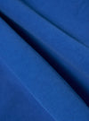Close-up of the Paraboot x Universal Works Navy Derek Twill Warmus Jacket fabric. The twill weave is visible in a vibrant navy blue.