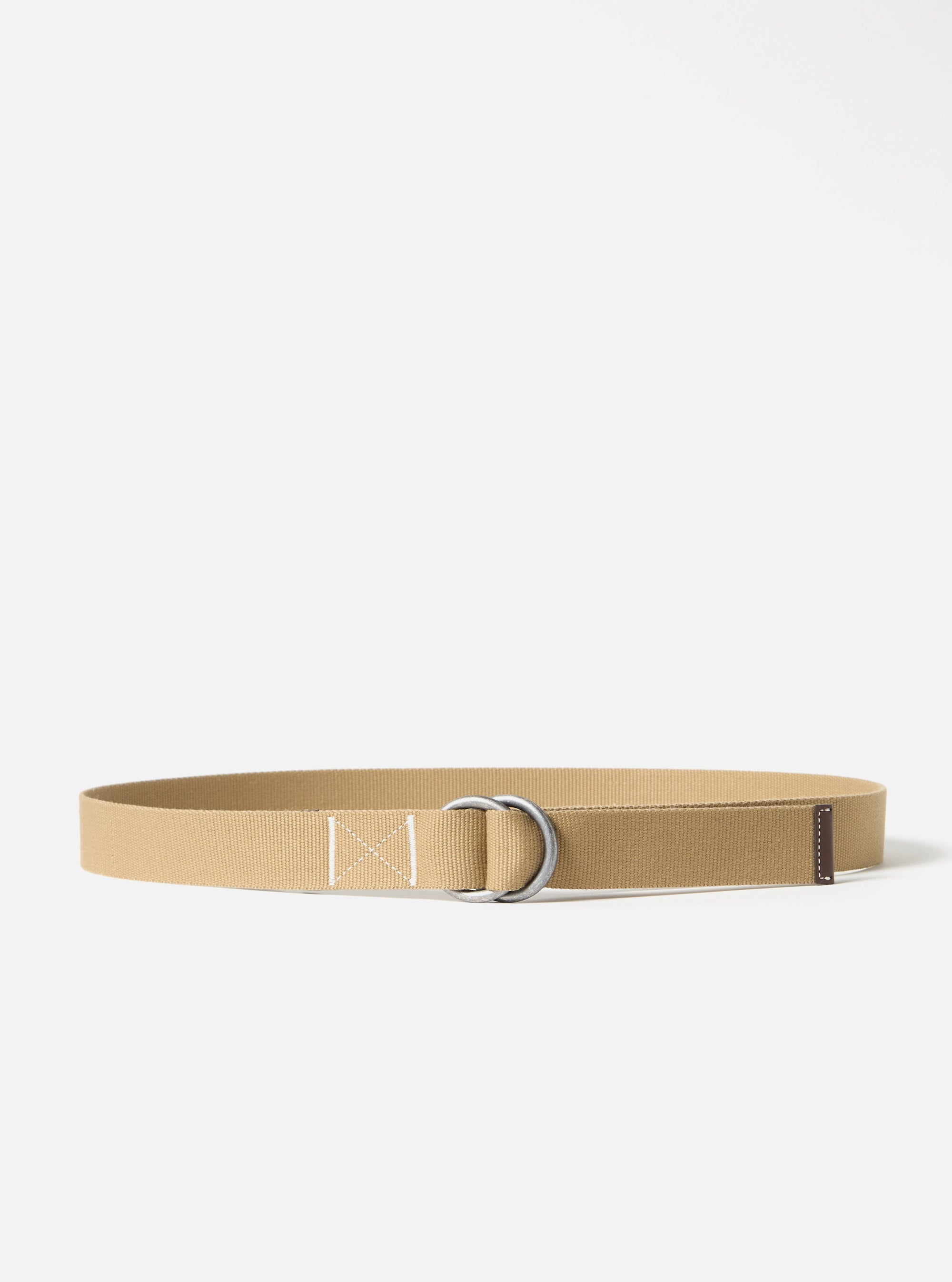 The Sand Canvas O Ring Belt on a white background. The belt is made of sand-colored canvas with a silver O-ring buckle and brown leather detail.