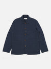 The Navy Twill Bakers Jacket is displayed on a white background. The jacket is a dark navy color and has brown buttons. It has a relaxed fit and is made of a twill material.