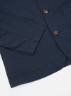 Close-up of the navy twill Bakers Jacket on a white background. Shows the jacket's texture, buttons, pockets, and sleeve.
