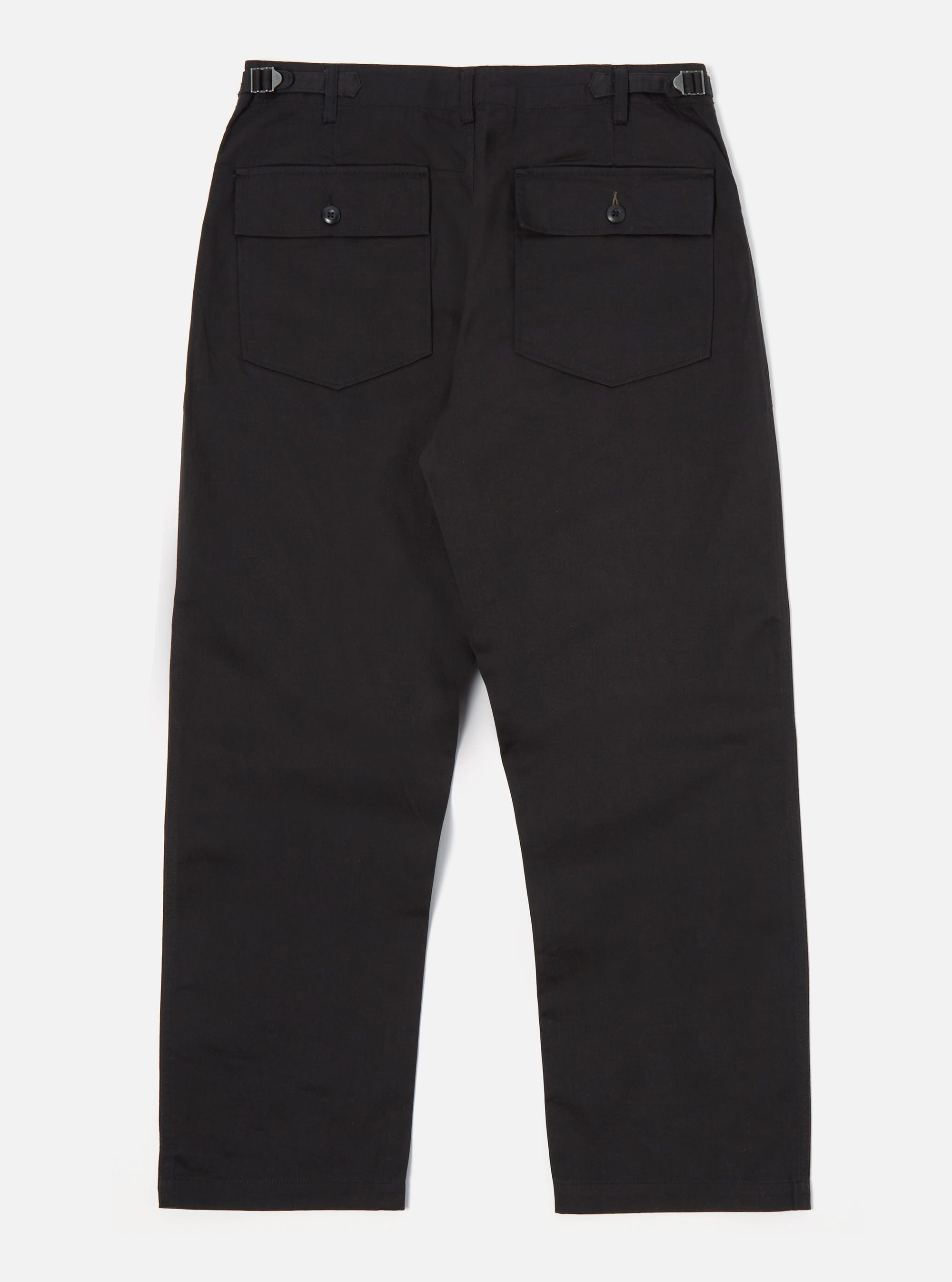 Back view of the Black Twill Fatigue Pant (Undarted) on a white background. These black pants have a relaxed fit and feature two back pockets with button closures.