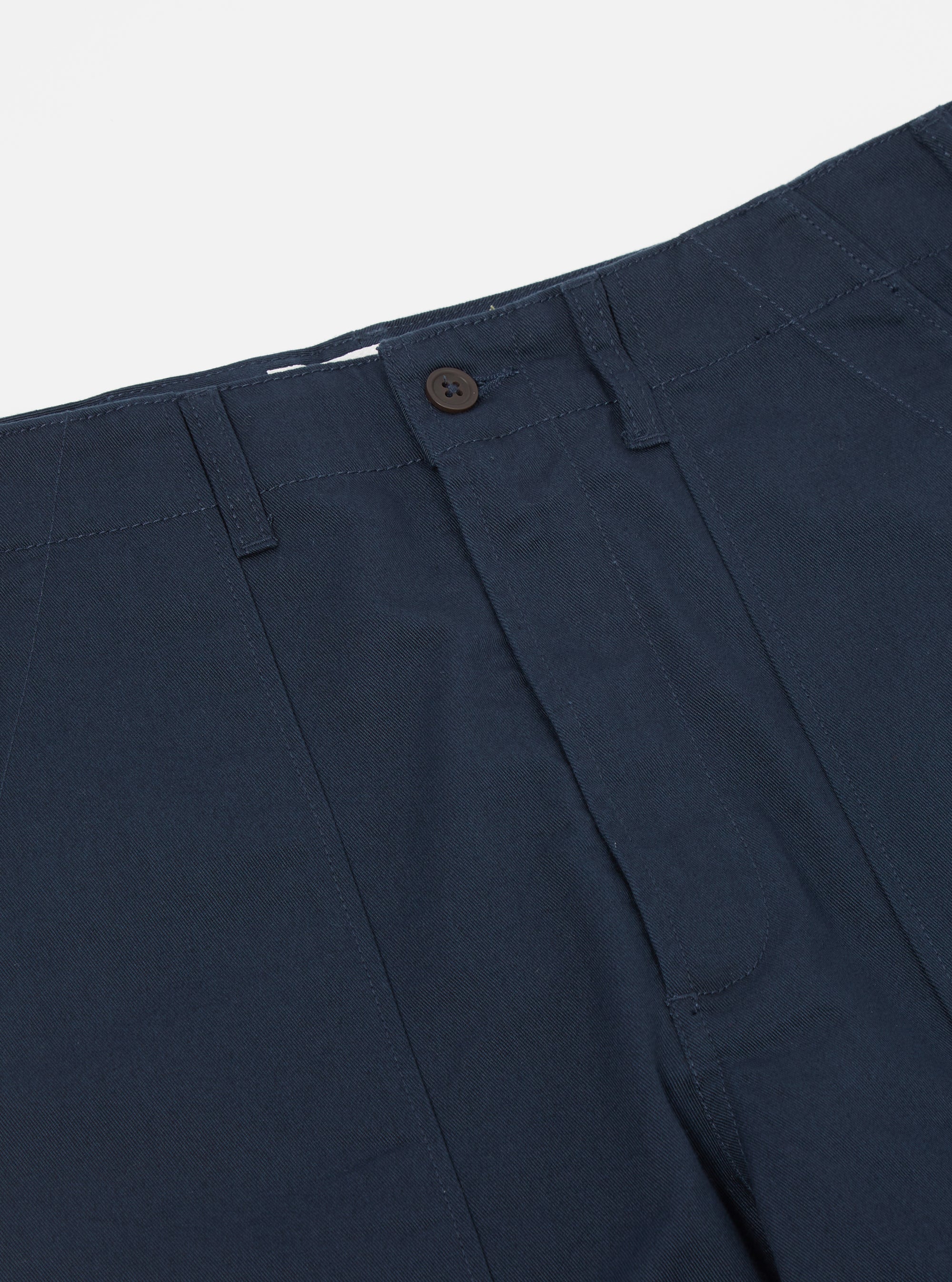 Close-up of the Navy Twill Fatigue Pant (Undarted) on a white background. The twill fabric is a deep navy, with a button closure and belt loops visible.