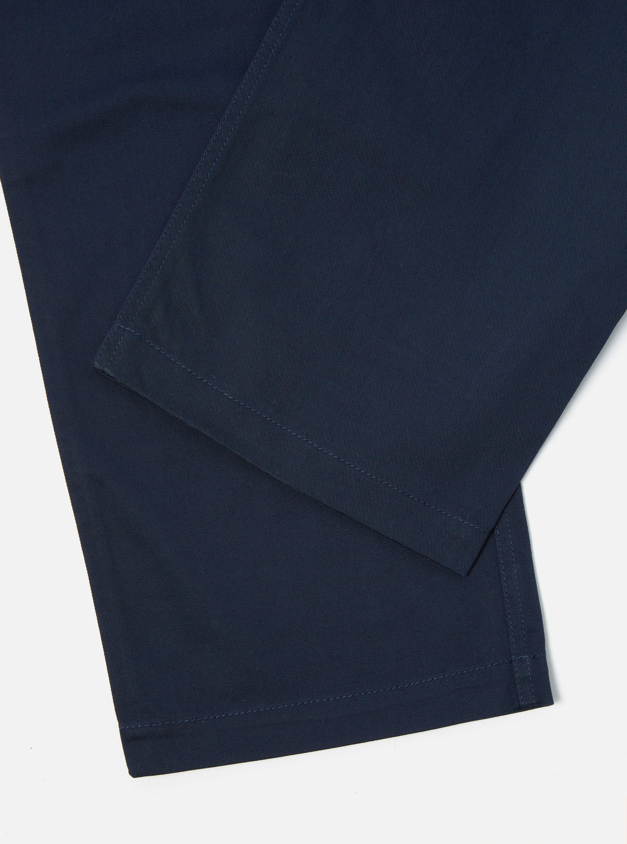 Close-up of the Navy Twill Fatigue Pant (Undarted) in navy twill on a white background. Shows the texture and seams.
