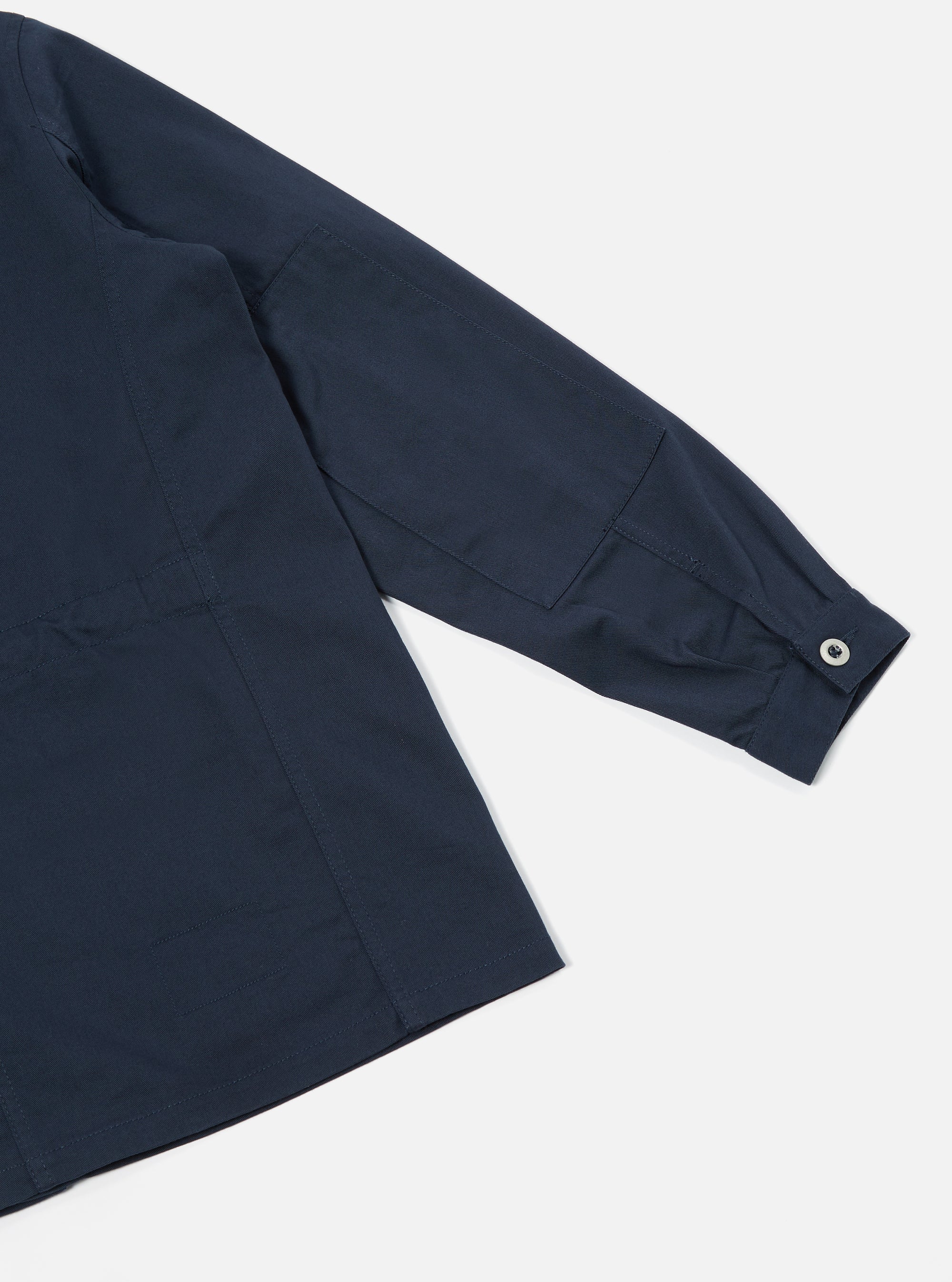 Close-up of the Navy Twill MW Fatigue Jacket on a white background. Shows the sleeve, pocket detail, and twill fabric.