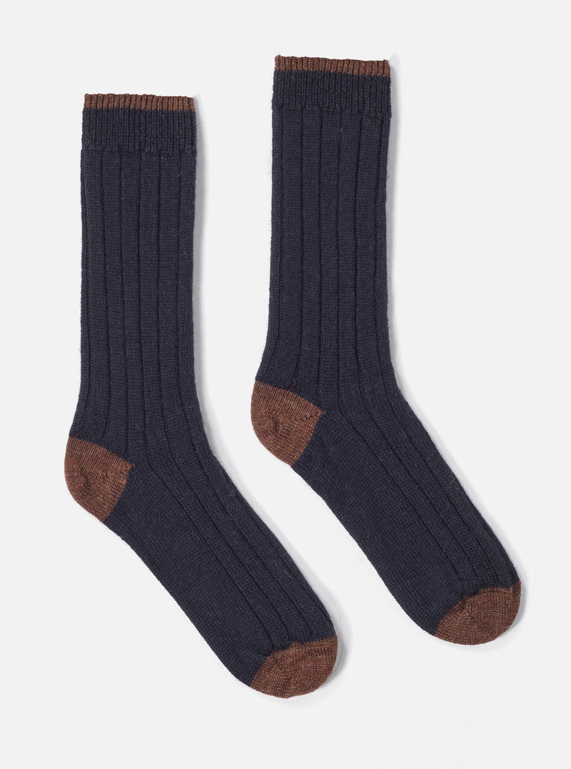 Two Navy Wool Hike Sock on a white background. The socks are ribbed and have brown toes and cuffs.