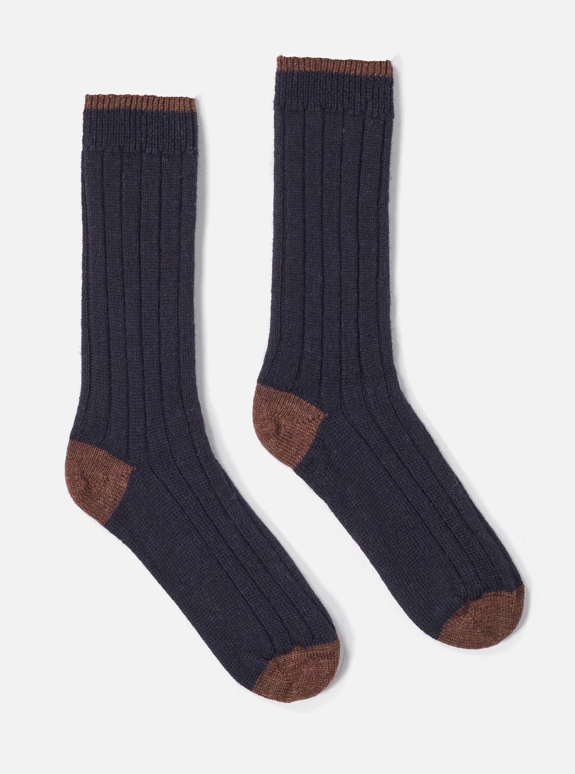 Two Navy Wool Hike Sock on a white background. The socks are ribbed and have brown toes and cuffs.