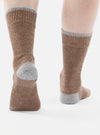 Close-up of a person wearing Brown Alpaca Wool Sock, with gray heel and toe, on a white background.