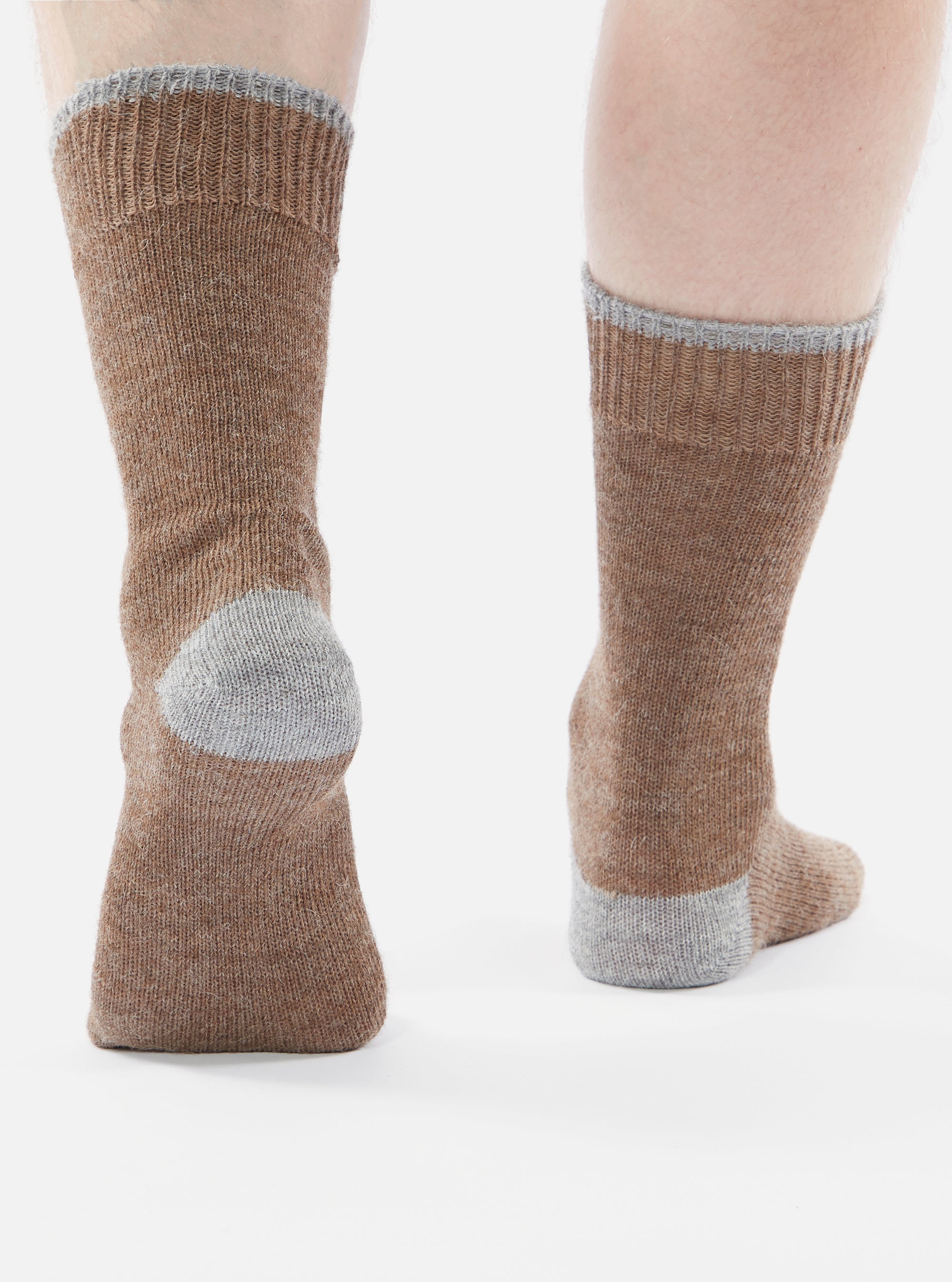 Close-up of a person wearing Brown Alpaca Wool Sock, with gray heel and toe, on a white background.