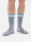 Close-up of a person wearing Cornish Blue Cotton Everyday Stripe Socks against a white background. The socks are striped at the top with blue and white.