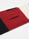 Close-up of a Black/Red/Ecru Soft Wool Deluxe Football Scarf on a white surface. The scarf features stripes of black, red, and ecru wool.