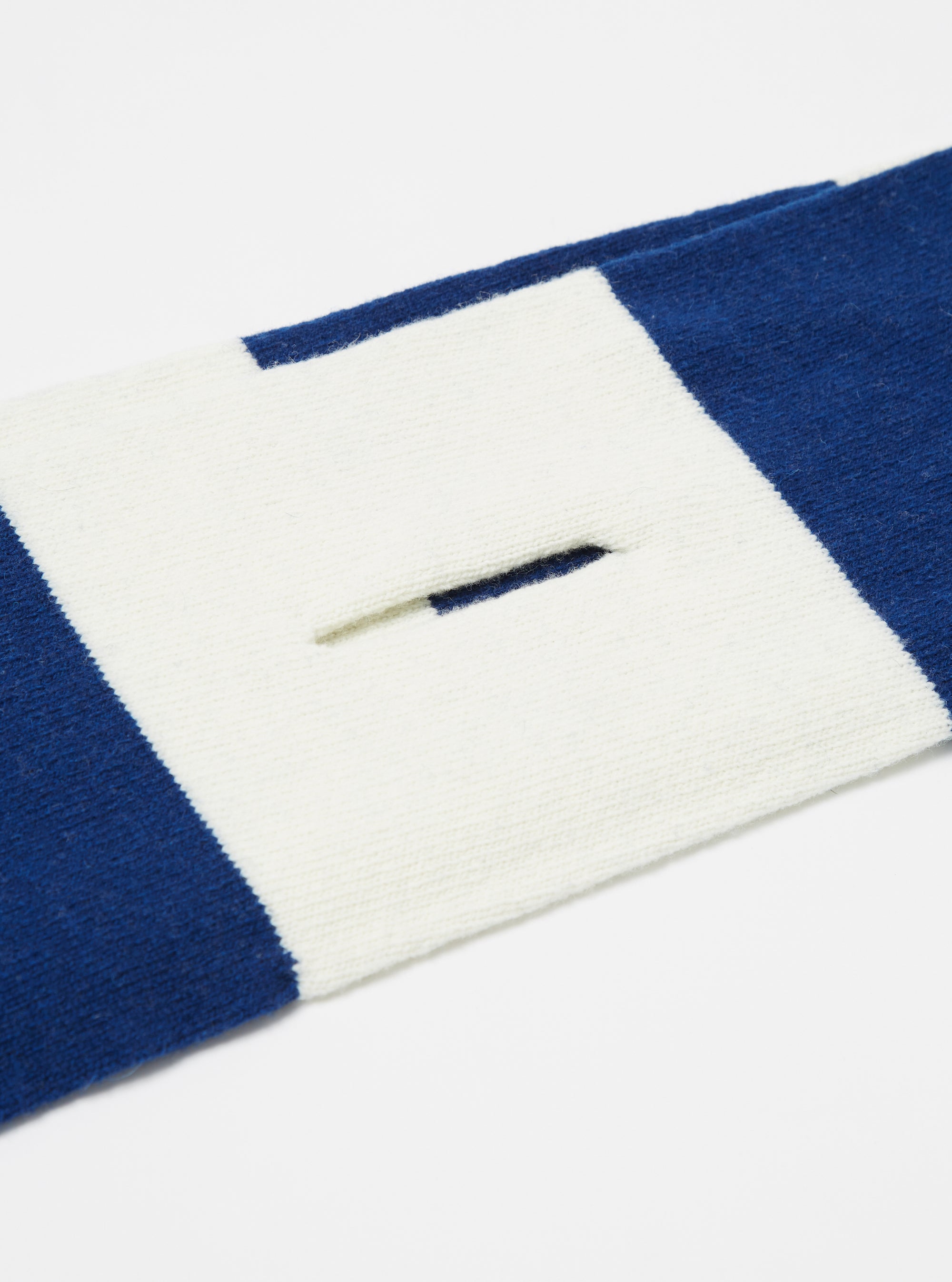Close up of the Ecru/Blue Soft Wool Deluxe Football Scarf on a white background. The scarf has ecru and blue stripes and a slit.