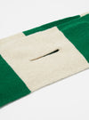 Close-up of the Beige/Green Soft Wool Deluxe Football Scarf on a white surface. The scarf features alternating beige and green stripes, made of soft wool.