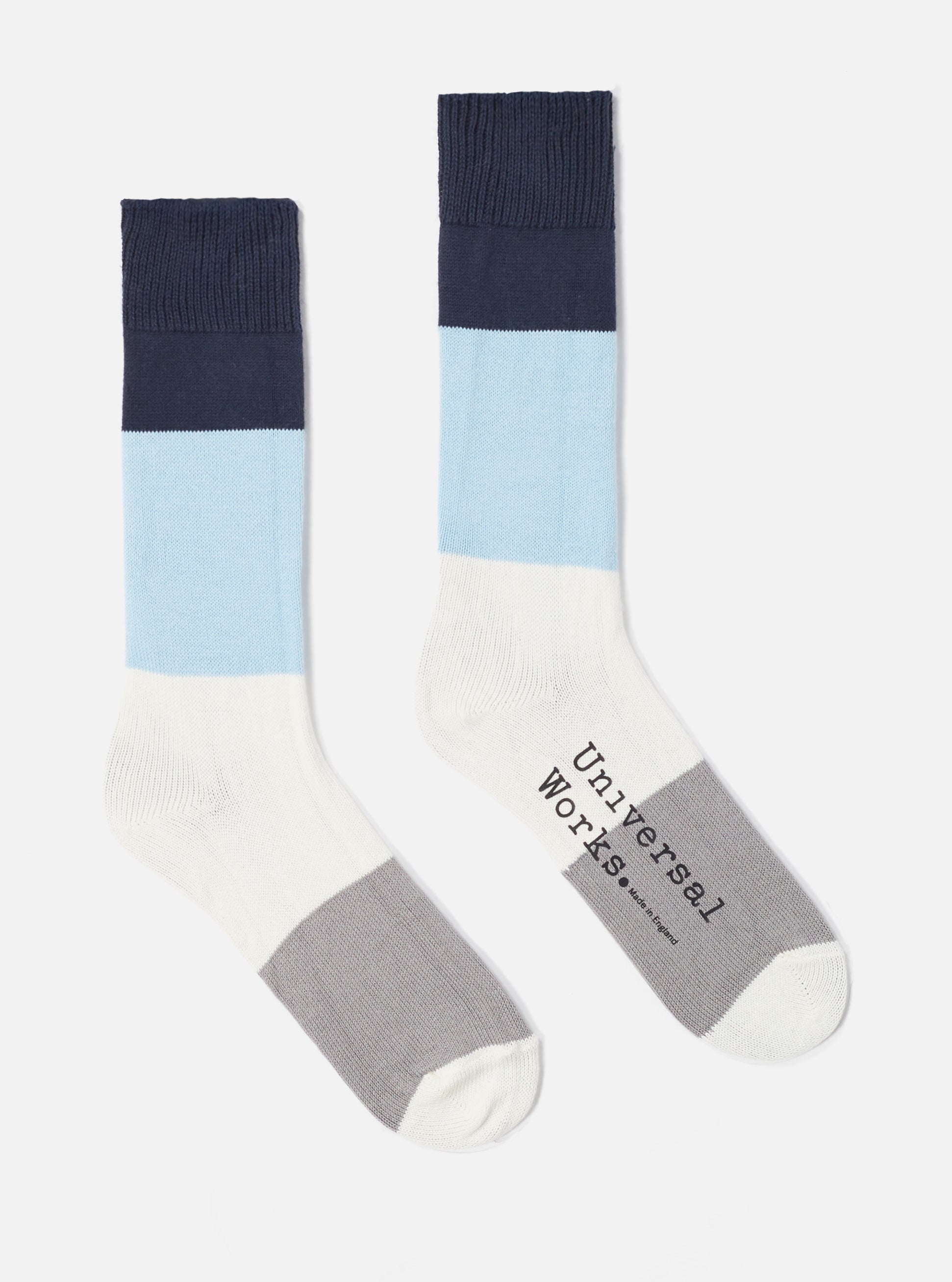 Studio shot on a white background of a pair of Navy/Sky Cotton Bold Stripe Sock. The socks have navy, sky blue, white and grey stripes.