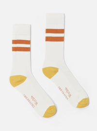Studio shot of Ecru/Orange Cotton Rib Sport Sock. White ribbed socks with orange stripes and orange toe and heel on a white background.