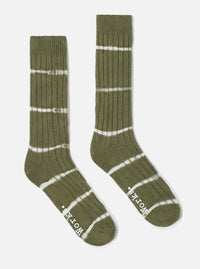 Studio shot of Olive Tie Dye Knit Slub Sock. Olive green knit socks with white tie dye stripes on a white background.
