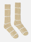 Studio shot of Dark Sand Tie Dye Knit Slub Sock. Ribbed knit with white tie dye stripes. 'Works' printed on foot. Soft cotton blend. On a white background.