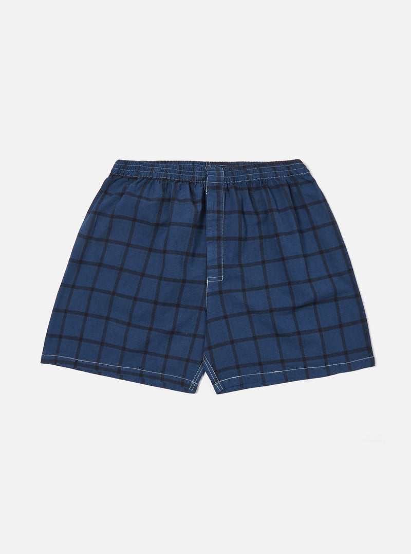Studio shot of Blue Check Boxer Short on a white background. The boxer shorts are blue with a black check pattern and have an elastic waistband.