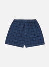 Studio shot of Blue Check Boxer Short on a white background. The boxer shorts are blue with a black check pattern and have an elastic waistband.