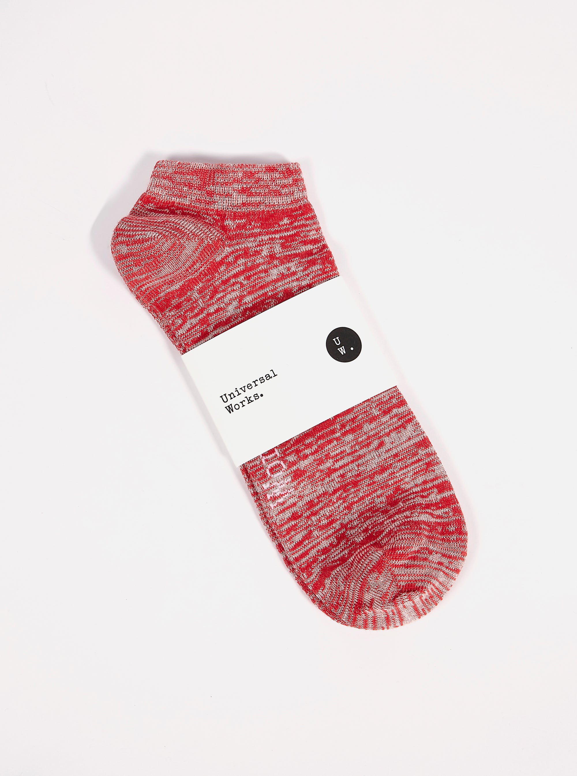 A Red Slub Knit Ankle Slub Sock on a white surface. The sock features a red and white slub knit pattern and is packaged with a white label.