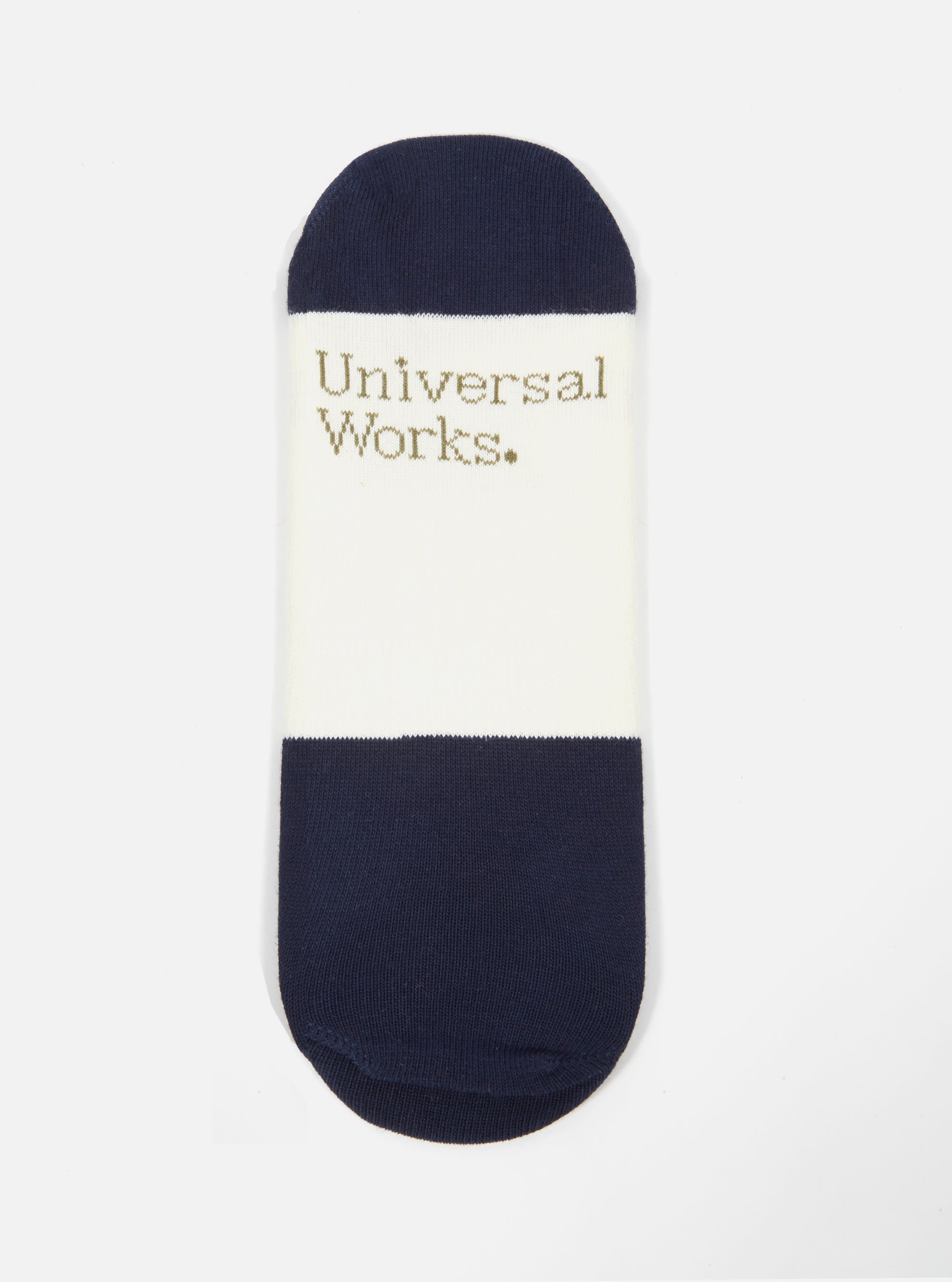 Close-up of an Ecru/Navy Cotton Mix Knit No Show Sock on a white background. The sock features navy blue ends and an ecru center with the brand name printed on it.