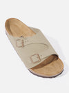 Studio shot of a Birkenstock Taupe Suede Zürich sandal on a white background. The sandal features adjustable straps and a contoured footbed.